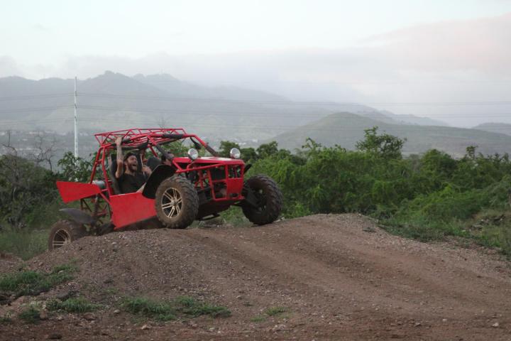 a truck driving down a dirt road