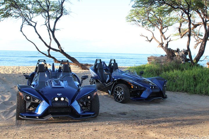 a motorcycle parked next to a body of water