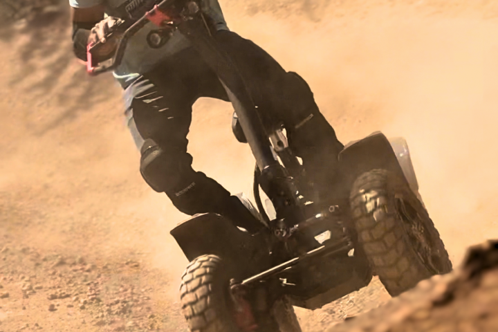 a man flying through the air while riding a bike down a dirt road