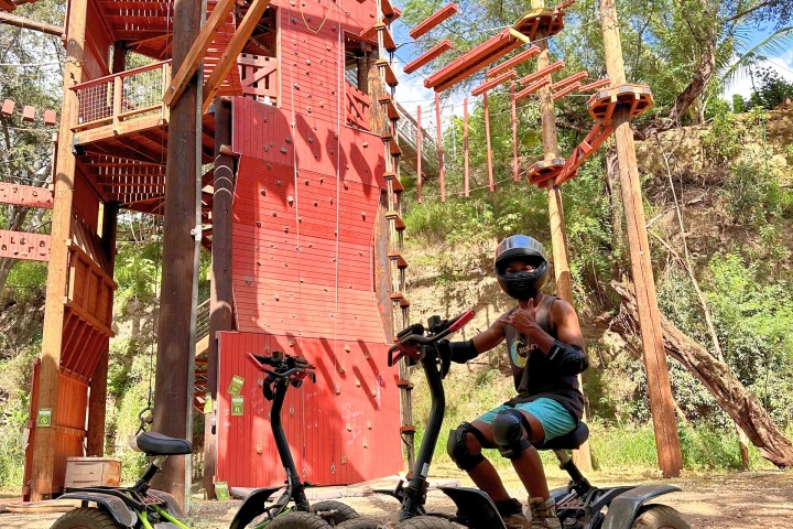 a man riding a motorcycle down a dirt road