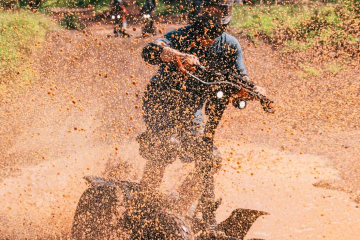 a person riding a bike down a dirt road