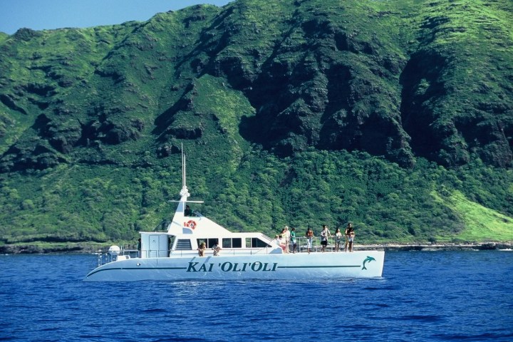a small boat in a body of water with a mountain in the background